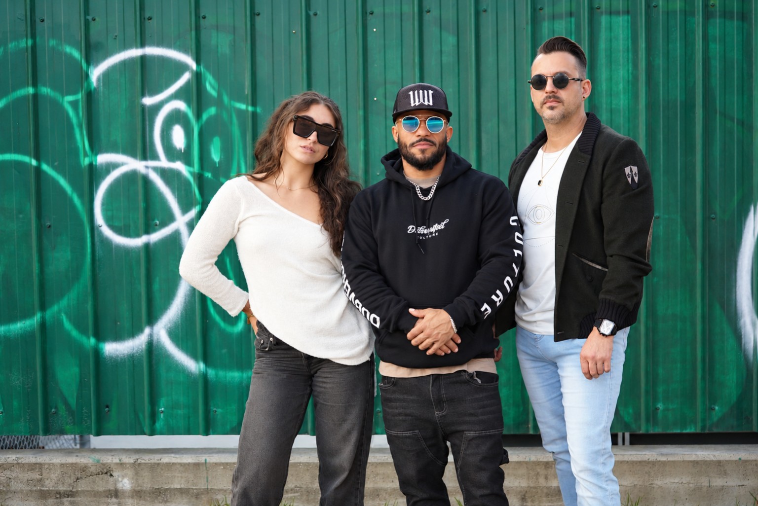 PSYOPS trio in front of a green wall